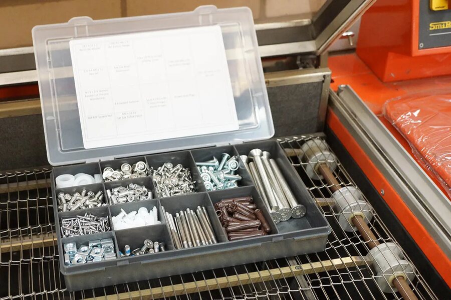 Labeled parts bins used to stage a custom kitting program
